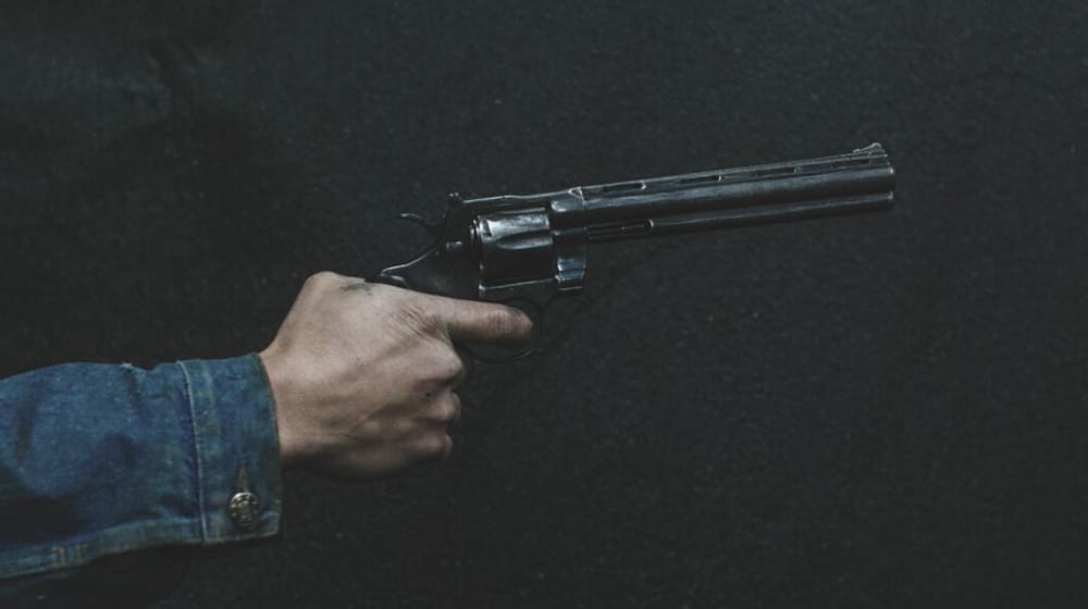 man holding a revolver | Developing Story: Active Shooter At The Naval Medical Center San Diego | active shooter incidents