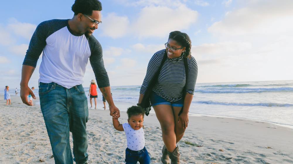 man in black and white striped long sleeve shirt holding baby | US Birth Rates In Trouble As More Americans Don’t Want Kids | featured