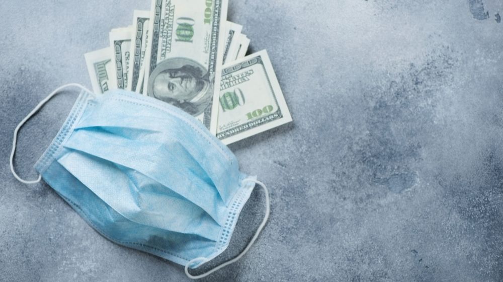 money and a facemask-USA Spends TRILLIONS to Cure Common Flu-ss-Featured