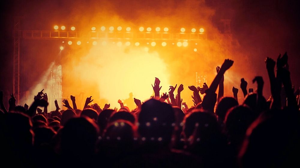People enjoying a concnert | Live Nation to Launch a Refund Program for Canceled and Rescheduled Shows Caused by COVID Pandemic | Featured