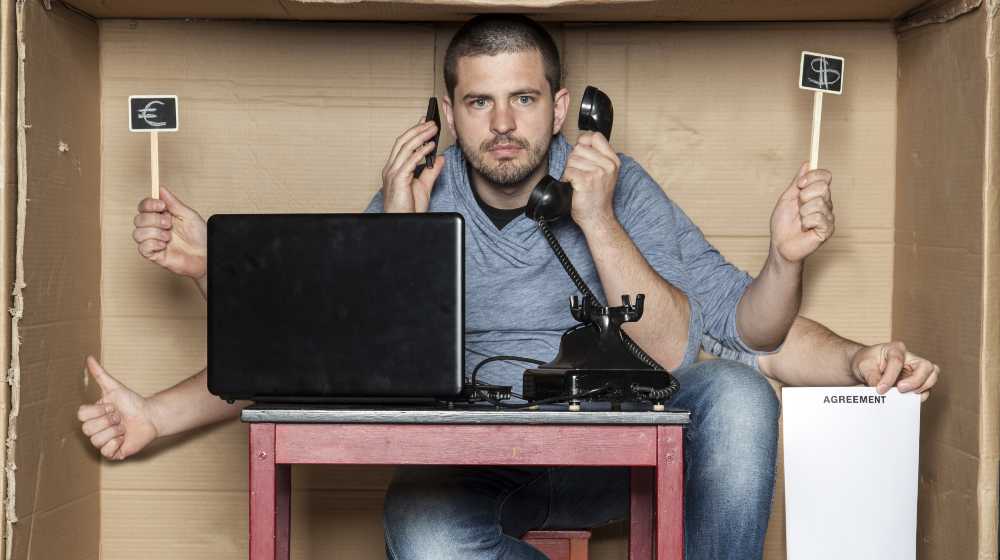 young man in the office box is a very multitasking | Tight Labor Market Ahead As Jobless Claims Fall to 54-Year Low | featured