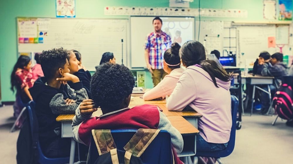 student listening to their teacher | Trump Claims 'Total' Authority, Over Governors, to Reopen Economy | Featured